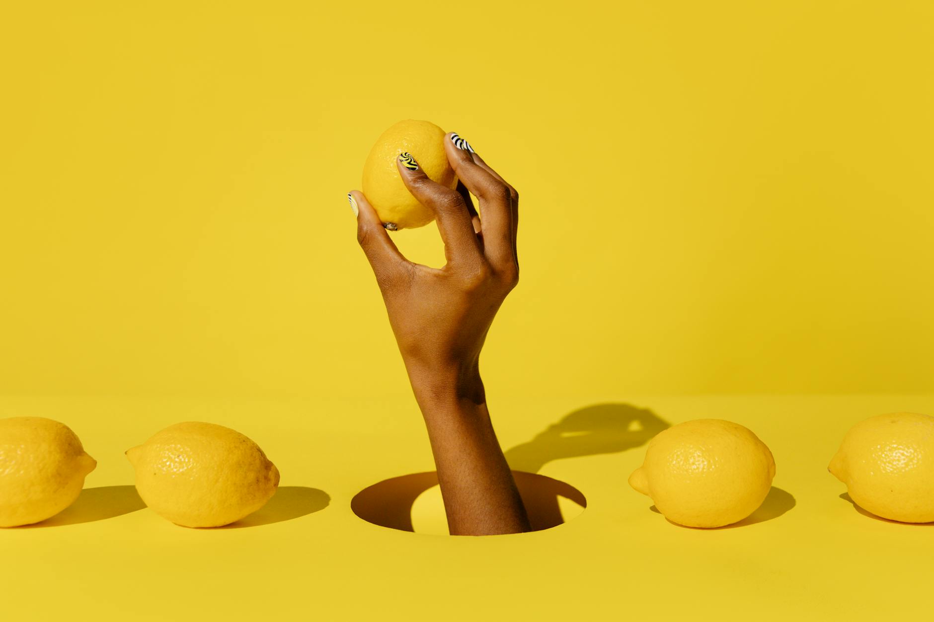 A hand reaching over a variety of colorful vibrators arranged on a table, representing choices and exploration