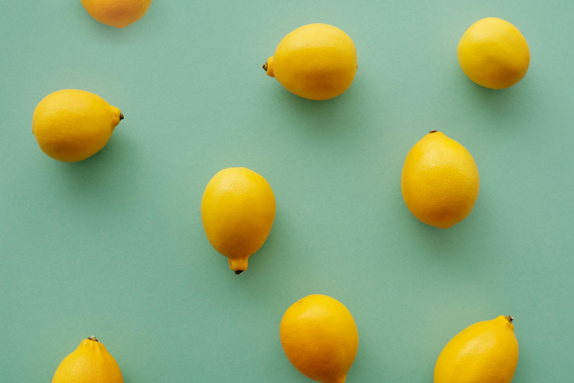Bright yellow lemons on a soft pastel background, symbolizing fresh approaches to intimacy