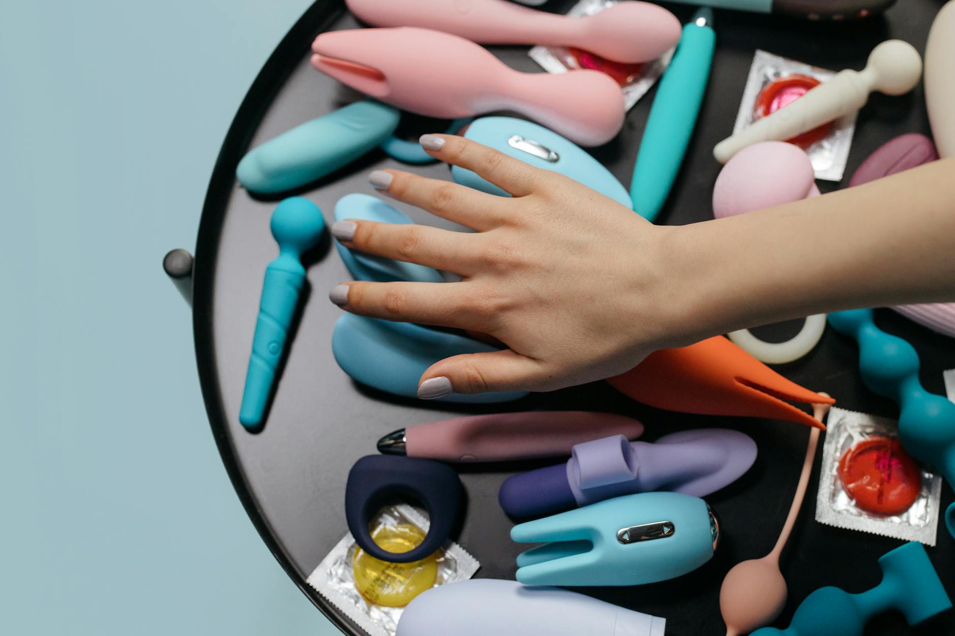 A selection of colorful vibrators arranged on a table, including lemon clitoral vibrators.