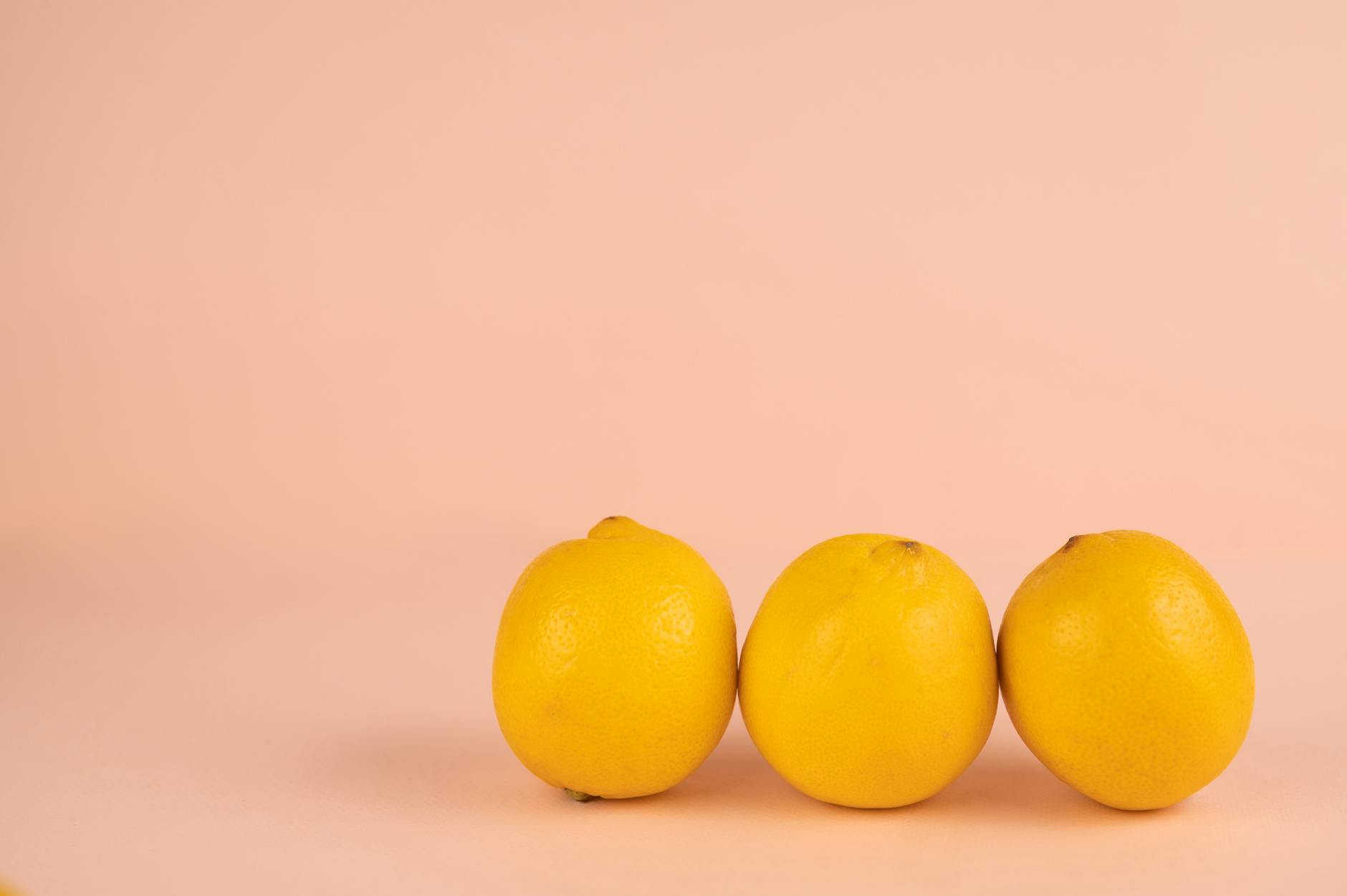 Bright ripe lemons on a pastel background, symbolizing freshness and joy